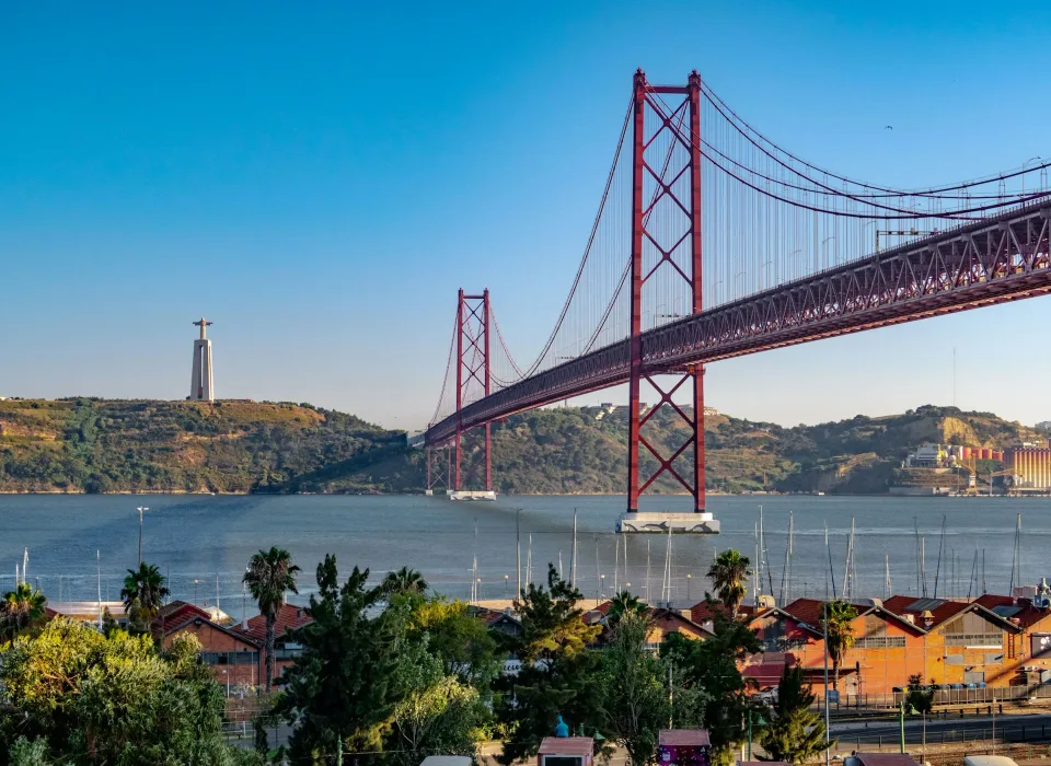 The 25 de Abril Bridge and the Cristo Rei statue across the Tagus in Lisbon